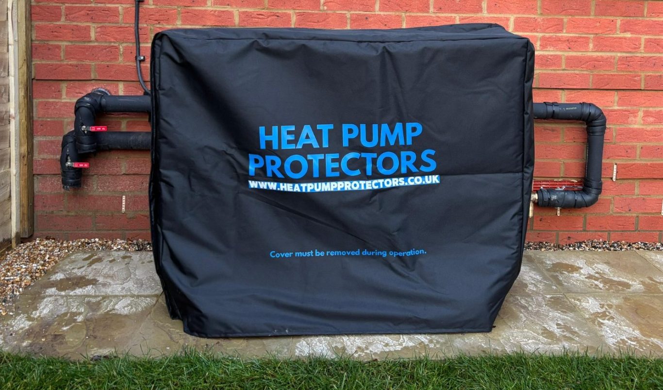 A Heat Pump Protectors Cover Black cover for a heat pump, featuring the text "HEAT PUMP PROTECTORS" in blue.